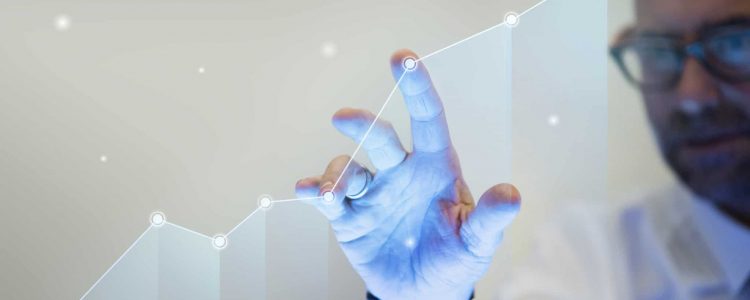 Businessman pointing his finger to a growth graph