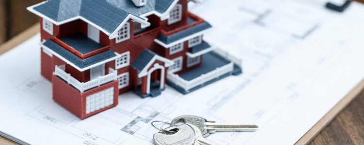 Villa house model, key and drawing on retro desktop (real estate sale concept)